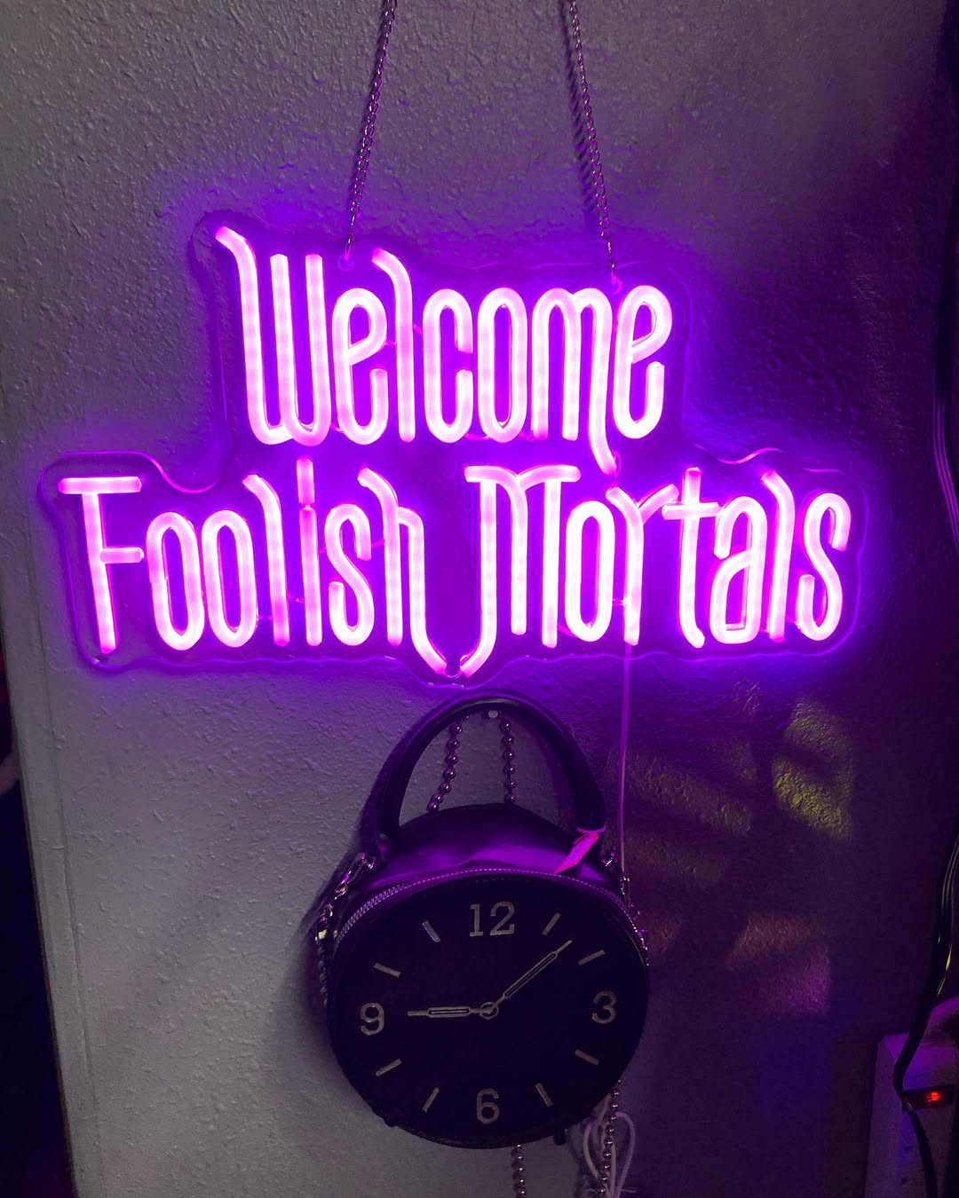 A glowing neon sign which says, &ldquo;Welcome foolish mortals.&rdquo;